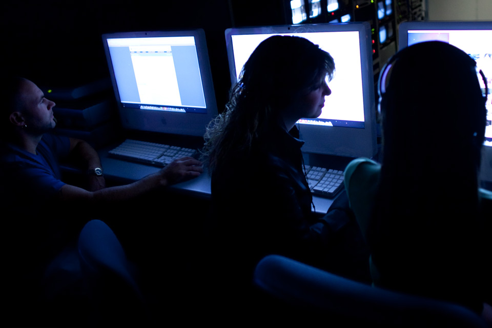 Students facing computer terminals